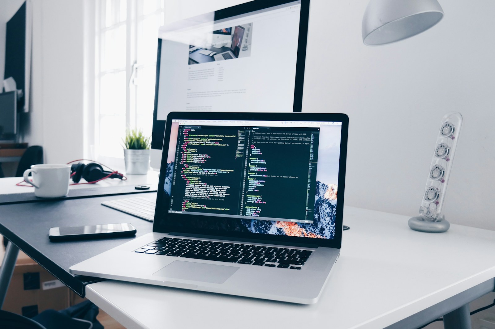 Ruang kerja pengembangan software dengan laptop dan perangkat teknologi